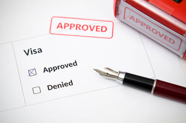 Visa and approved stamp on a document form. Immigration and travel concept Visa and approved stamp on a document form. Immigration and travel concept