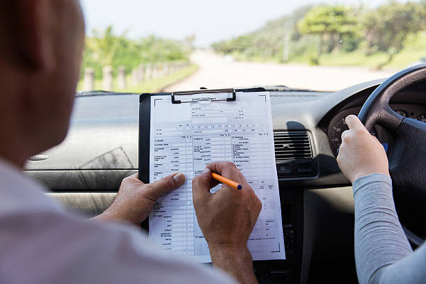 back view of girl taking driving test back view of girl taking driving test